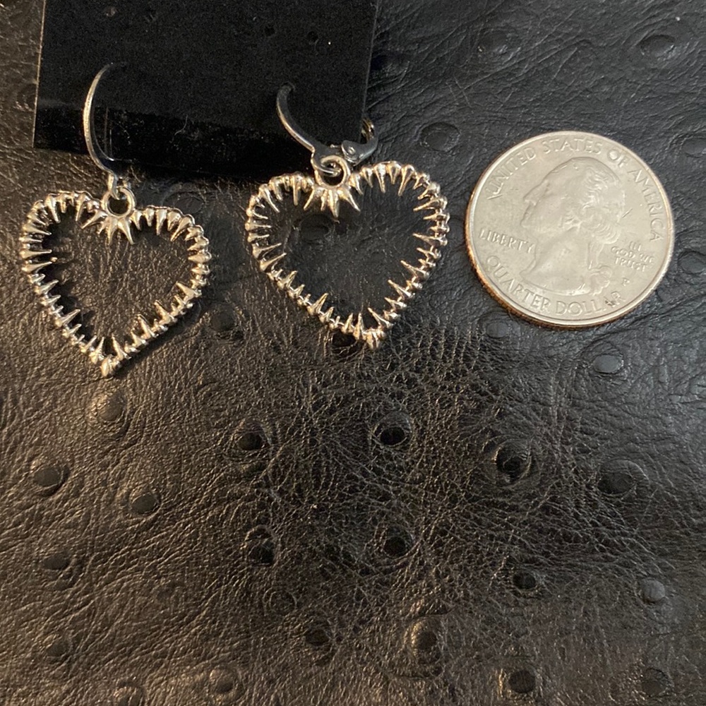 Alternative silver heart outline earrings dangling hoops